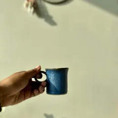 The feeling of a handmade cup in your hand is something special. This image shows the scale of the Cobalt Blue cup, perfect for a small, strong coffee or tea. The circular handle is designed for a comfortable grip.