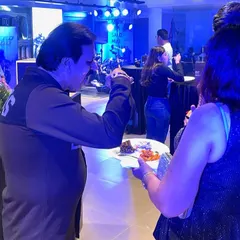 A guest enjoying a plate of our food at the Triumph motorcycle showroom launch. We ensure that even at a busy networking event, the food is delicious, easy to eat, and served professionally.