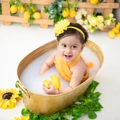 A playful moment in the tub. These sessions are all about capturing the fun and splashes as your baby enjoys the warm milk bath.