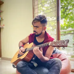 A relaxed moment at home, just me and my guitar. This is where new ideas are born and where I practice for hours to perfect my craft for live shows.