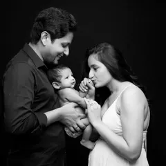 An alternative angle from a classic family newborn session. We focus on capturing genuine interactions, like the mother's gentle kiss on her baby's tiny hand.