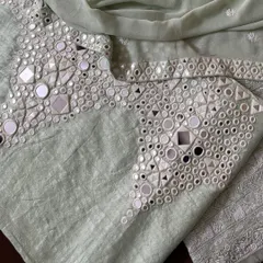 A close-up of the palazzo's hem, where intricate mirrorwork provides a striking contrast to the delicate Chikankari on the kurta.