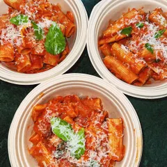 Our Rigatoni Alla Vodka, packed in eco-friendly bowls and topped with fresh parmesan and basil. It's one of our most popular delivery items.