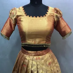 Another example of a pattu saree converted into a lehenga. The blouse has a unique zigzag neckline, and the skirt is neatly pleated to show off the saree's original pattern.