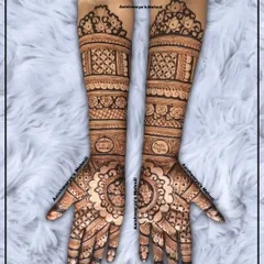 A stunning engagement bridal design with matching mandala patterns on both palms. The arms are filled with detailed geometric and floral bands.
