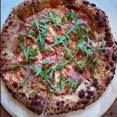 A delicious pizza topped with savory prosciutto and fresh, peppery arugula. The salty meat and fresh greens create a perfect balance of flavors on my classic Neapolitan crust.