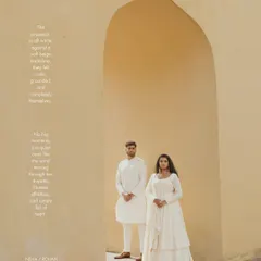 A classic portrait within a sandstone arch in Jaipur. The simplicity of the composition and the couple's coordinated white outfits create a serene and elegant pre-wedding photograph.