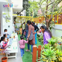 Families explore the various learning stations at our "Coconut Chronicles" event. Parent involvement is a cornerstone of the Smiti community.
