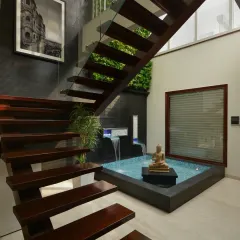 In the Gupta Residence, I integrated this tranquil indoor waterbody beneath a floating wooden staircase. This feature brings a sense of calm and nature into the core of the home, combining natural elements with contemporary architectural sophistication.