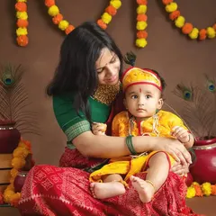 A mother and her baby dressed in traditional attire for a Janmashtami themed shoot. I offer festive setups to celebrate cultural holidays with beautiful portraits.