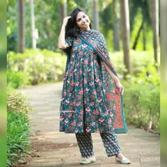 A full-length view of the dark green floral Anarkali-style kurta with its matching printed pants and dupatta. It's a complete, elegant outfit ready for any event.