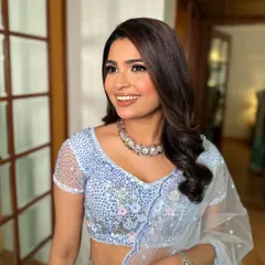 A beautiful, happy smile from Shraddha. Her makeup is fresh, elegant, and perfectly suited for a daytime or evening engagement ceremony.
