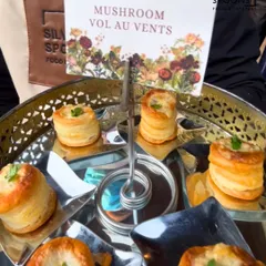 Delicate and savory Mushroom Vol-au-vents served on a tiered silver platter. These classic French pastries are filled with a creamy mushroom mixture, making for an elegant appetizer.