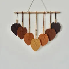 A custom macrame leaf hanging in beautiful shades of brown, from dark chocolate to light tan. The wooden beads add a lovely natural touch.