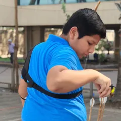 A young boy prepares his arrow during the selection trials. It's a test of skill and composure.