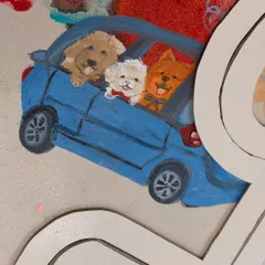 A close-up on a particularly sweet detail. This miniature painting captures the client's three dogs on a car ride, a memory they wanted to feature prominently in their custom relationship artwork.