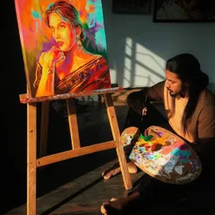A quiet moment of reflection in the studio. I'm sitting with my palette next to a recently completed colorful portrait of Trintrin.