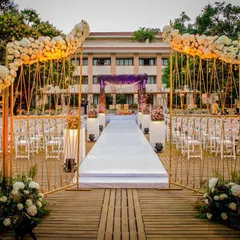 I designed this elegant outdoor entrance with golden arches adorned with white roses, leading to a pristine white aisle. It framed the venue beautifully and created a classic, romantic start to the ceremony.