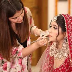 A candid moment of me working on my bride Soumya. The connection and trust between a makeup artist and a bride is so important, and I cherish these moments of focus and artistry.