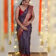 Here I am, styling my mom's 35-year-old reception saree. This checked silk saree with a rich red and gold border is a timeless piece. It feels so special to wear something with so much history.