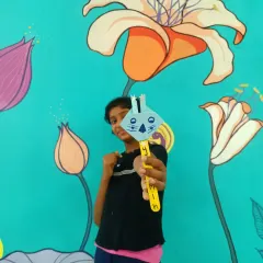 A young girl proudly displays her bunny craft. After a story session, these activities help children connect with the story's themes on a deeper level, turning abstract ideas like hope and rebirth into something they can hold.