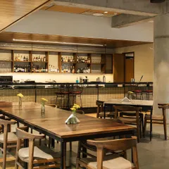 Welcome to my restaurant, Coracle, located at the Bangalore International Centre. I wanted to create a space that feels modern but not stiff, perfect for a cozy family dinner or a quiet meal. We also have a full bar to help you unwind.