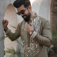 A smiling client wearing the mirror-work kurta, showing how it combines traditional craft with modern style.