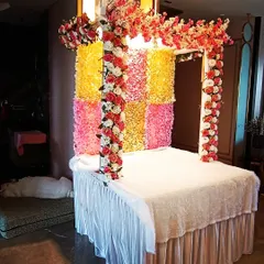 A side view of the floral Ganpati mandap, showing the structure and the arrangement of the flower garlands on the pillars.