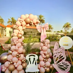 A closer view of the elegant butterfly party decor, highlighting the custom name sign and the soft pink and gold color palette.