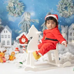 A little one's first Christmas. My festive mini sessions include adorable Santa outfits and a winter wonderland setup to capture this special milestone.