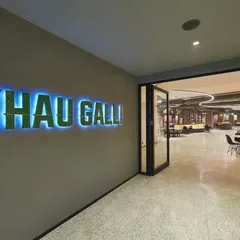 Another view of the "Khau Galli" entrance, with backlit signage that creates a vibrant glow. This leads into a large, dynamic cafeteria space.