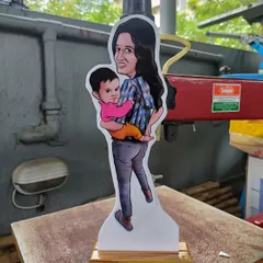 A miniature caricature cut-out of a mother and her child. These statues are a wonderful way to capture a precious family moment.