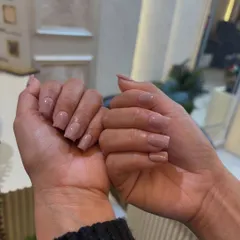 Another view of our classic nude manicure on square nails. A perfect choice for a professional and polished look.