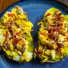 Today's breakfast is avocado toast with scrambled eggs and bacon. Using fresh ingredients from the garden makes every meal special.