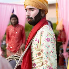 A dhol player in traditional attire, ready to bring the high-energy beats of Punjab to the party. The combination of DJ and dhol is always a crowd favorite.