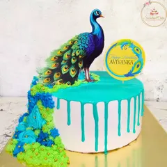 This peacock cake is a perfect example of my passion for detailed artistry. I used careful piping and a vibrant color palette to create the peacock's flowing train, all with fresh cream, making it a stunning and delicious centerpiece for a special birthday.