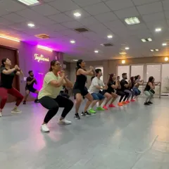 It's not just about cardio. We incorporate strength and conditioning moves into our routines to build muscle and endurance. Here you can see the whole class powering through a set of squats together.