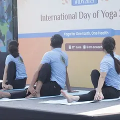 My students performing a synchronized seated spinal twist during an outdoor event, showcasing precision and group coordination.