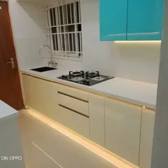 A look at a modern kitchen layout we completed, showcasing a clean and efficient workspace. This design features dual-tone cabinetry, a durable white countertop, and integrated floor and under-cabinet lighting that makes the space feel bright and spacious while providing excellent task illumination.