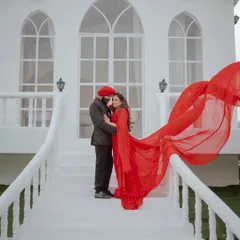 A stunning anniversary portrait with a flowing red gown. It proves that you don't need a wedding to have a glamorous and romantic photoshoot to celebrate your love.