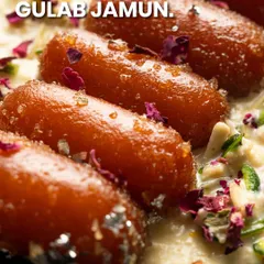 My Gulab Jamun is served in a creamy rabri and garnished with rose petals, a truly royal treat.