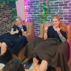 Happy clients enjoying a relaxing pedicure session together in our comfortable salon chairs.