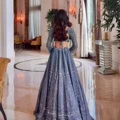 The back of this exquisite blue lehenga deserved its own moment. The soft waves of her hair cascade down, complementing the intricate details of the outfit. This shows how I consider the entire look, from makeup to hair to outfit.