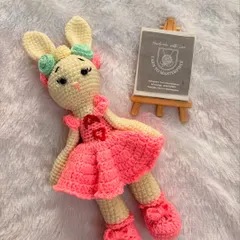 This customized bunny doll is dressed in a pink frock with a personalized initial 'A' on the chest, making it a truly special keepsake.
