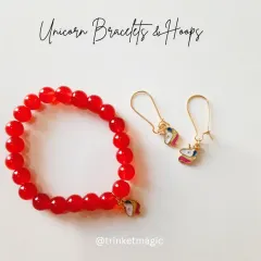 The unicorn bracelet and hoop set in a vibrant red. The glossy red beads contrast beautifully with the magical unicorn charm.
