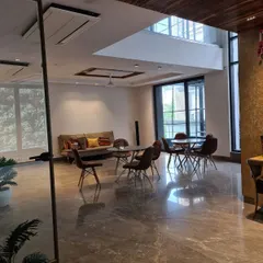 An on-site image of a project in progress, showing the expansive marble floors and large windows. This 'before' shot provides context for the level of transformation our design work entails.