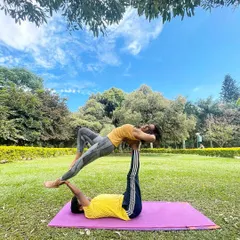 An outdoor Acro Yoga session in Cubbon Park. This pose, known as a therapeutic backbend for the flyer, feels amazing and really opens up the heart space.