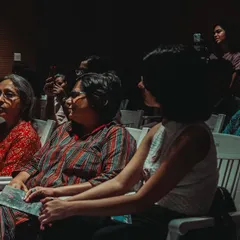 The audience, completely absorbed in a performance or discussion. These moments of shared focus and quiet contemplation are just as important as the loud 'galatta'.
