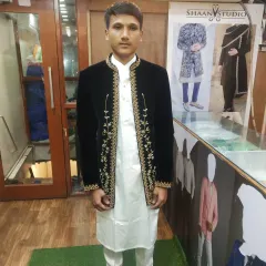 The texture of velvet adds a touch of luxury to any outfit. This client is wearing a custom-fitted black velvet Jodhpuri jacket, elevated with delicate gold embroidery along the front opening for a regal and sophisticated finish.