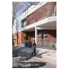The 'House Under Tabebuia Trees' features a 15-meter panoramic and parametric facade. This curved form, a significant structural challenge, was designed to wrap around the view, creating a dynamic interplay of light and shadow that changes throughout the day. It is a testament to our fascination with bold, cantilevered structures.
